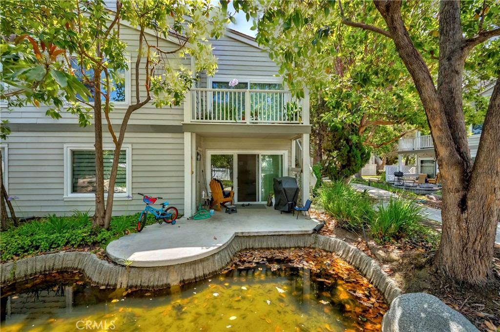 22224 South Vermont Avenue, Unit 102C Torrance, CA 90502 - Photo 6 of 27 a front view of a house with a yard table and chairs
