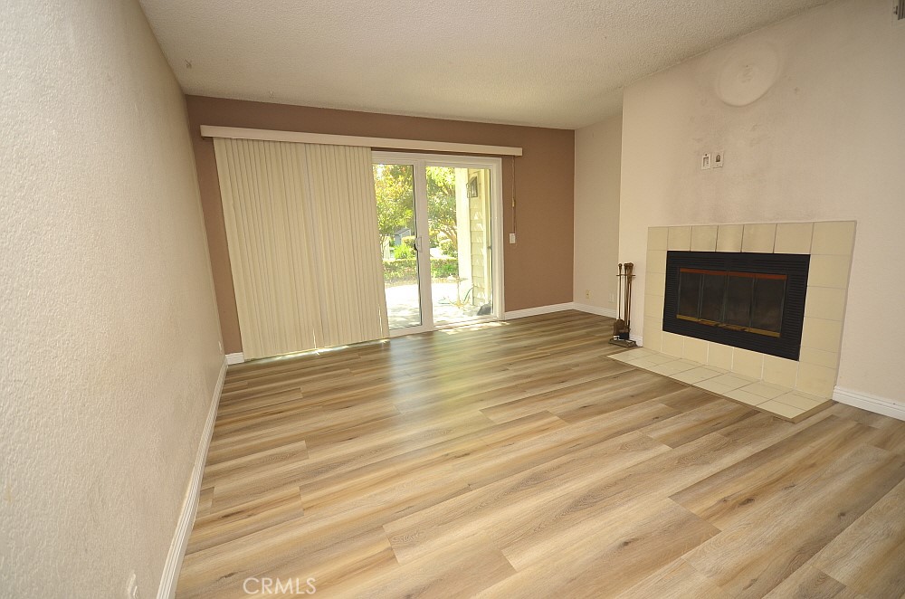 22224 South Vermont Avenue, Unit 102C Torrance, CA 90502 - Photo 8 of 27 a view of an empty room with wooden floor and a window