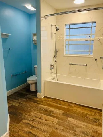a bathroom with a toilet bathtub and shower
