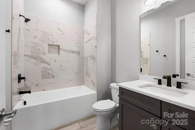 a large bathroom with a tub a double vanity sink and a large mirror