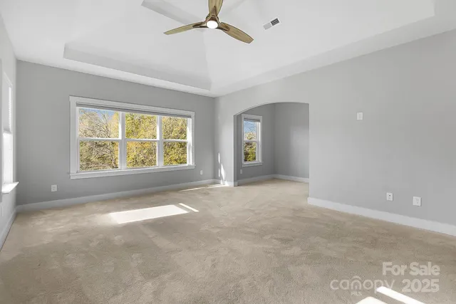 an empty room with windows and pillars in it