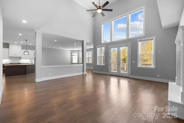 a kitchen with stainless steel appliances granite countertop a stove a sink and a wooden floors