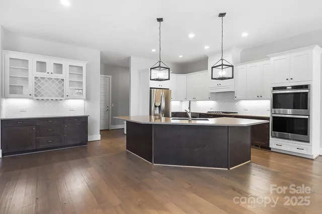 a kitchen with cabinets and wooden floor