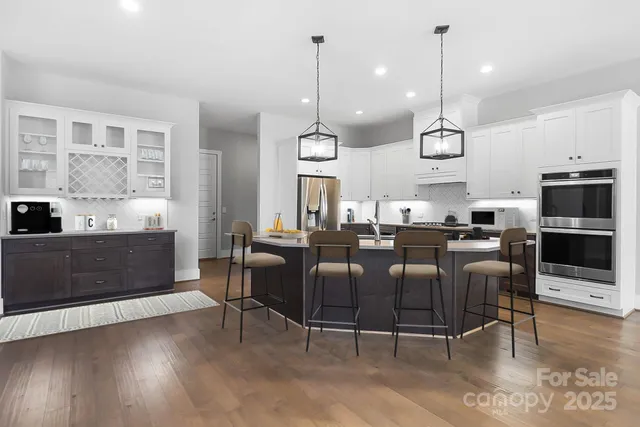 a kitchen with stainless steel appliances granite countertop a refrigerator and a stove