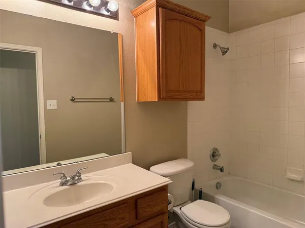 a bathroom with a sink toilet a mirror and shower