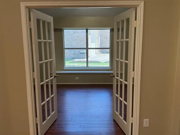 a view of front door with wooden floor and a window