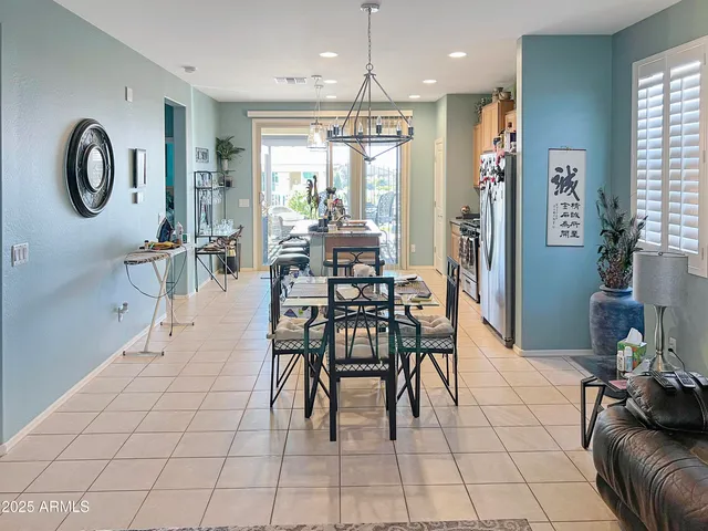 a dining room with furniture and a chandelier