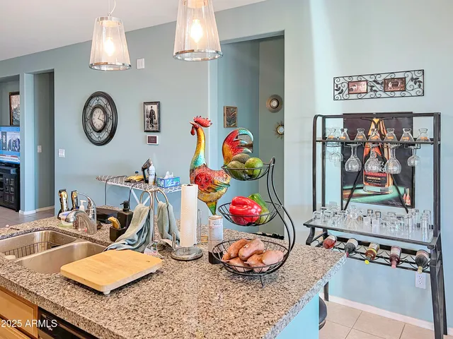 a bedroom with a bed a window and a chandelier