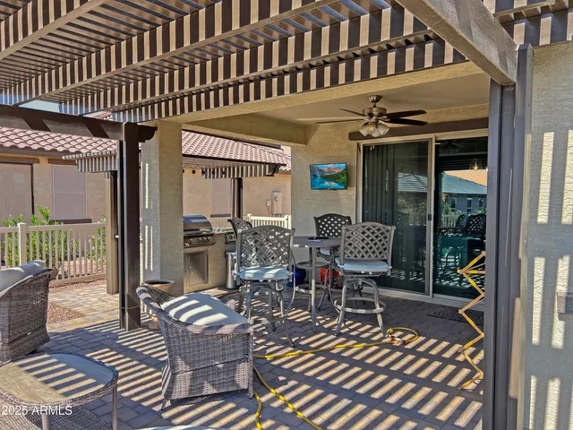 a view of a patio with couches table and chairs and potted plants