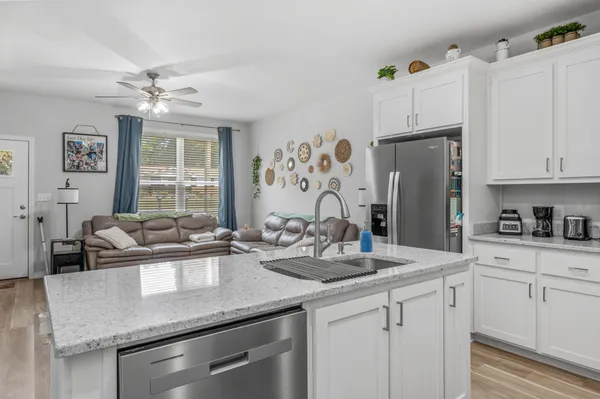 a kitchen with granite countertop a stove and a microwave