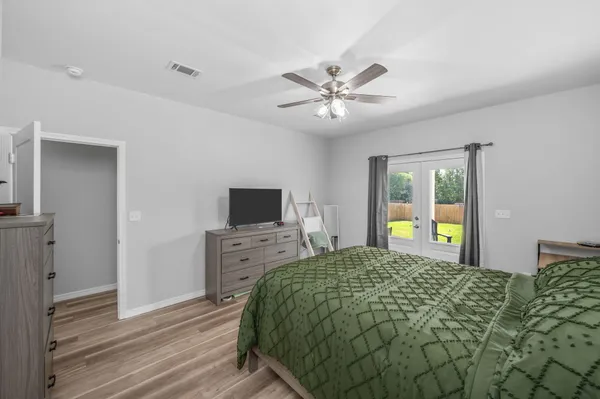 a bedroom with a bed and a flat screen tv