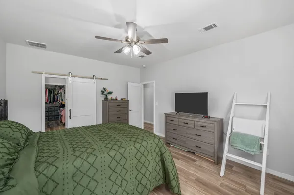 a bathroom with a granite countertop double vanity sink and a mirror