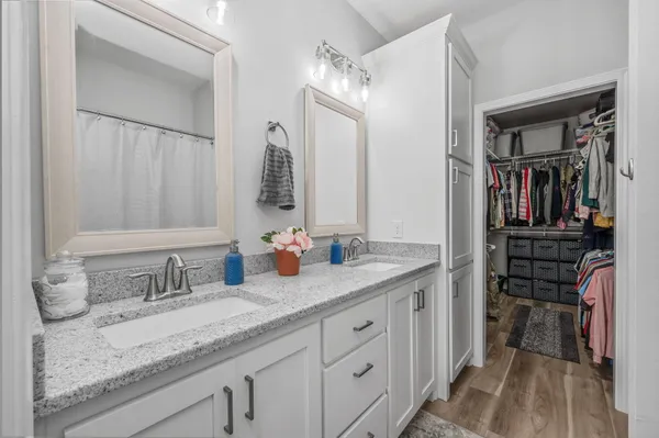 a bathroom with a granite countertop sink mirror and vanity