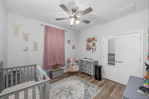 a bedroom with furniture a baby crib and a couch