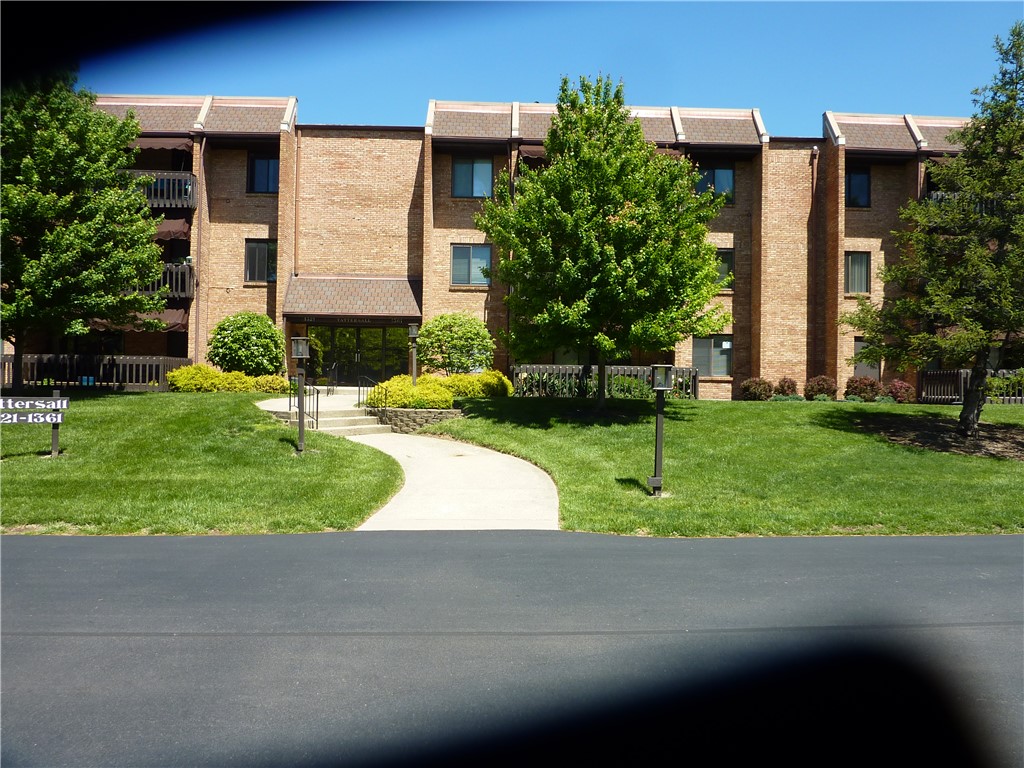 A well-maintained apartment building with lush landscaping and a welcoming entrance.
