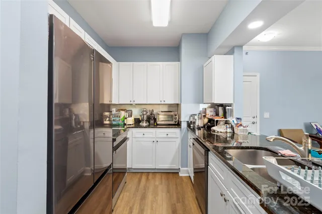 a kitchen with a sink stove and refrigerator