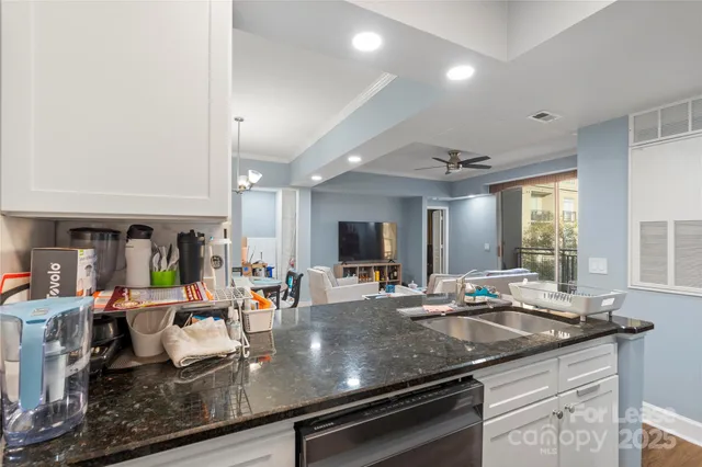 a kitchen with granite countertop a sink and cabinets