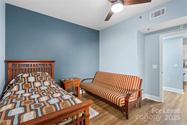 a bed room with two beds and a night stand