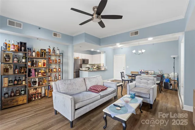 a living room with lots of furniture and a book shelf