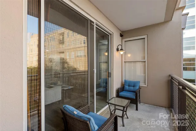 a view of a room with furniture and windows