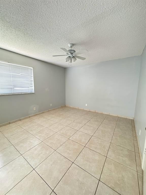 2866 South University Drive, Unit 5101 Davie, FL 33328 - Photo 4 of 6 a view of an empty room with a chandelier fan