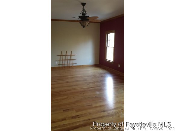 2341 Zacks Mill Road Angier, NC 27501 - Photo 22 of 25 a view of a hallway with a window and a ceiling fan