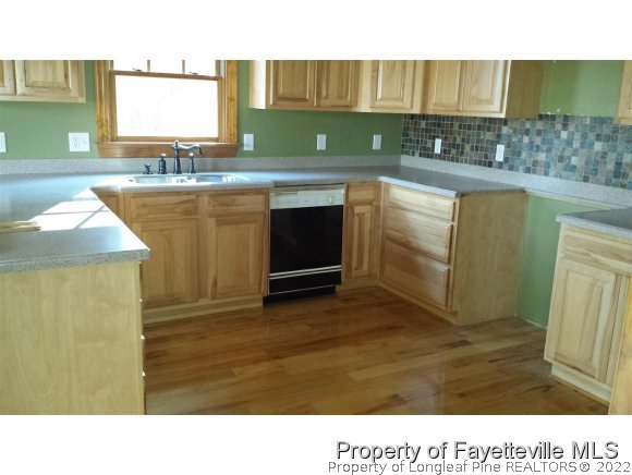 2341 Zacks Mill Road Angier, NC 27501 - Photo 24 of 25 a kitchen with a sink and cabinets