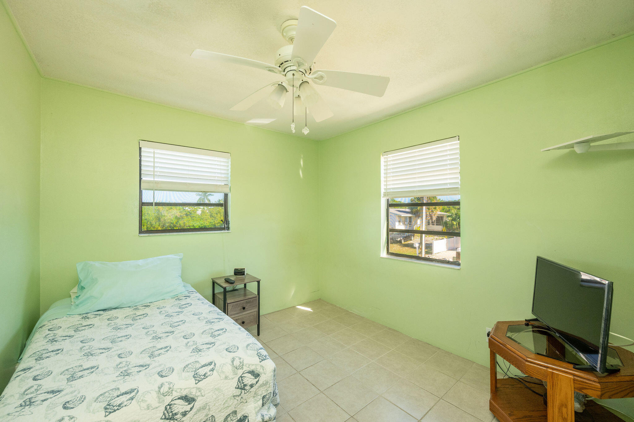 3856 Donna Road Big Pine Key, FL 33043 - Photo 13 of 28 a bedroom with a bed and a window