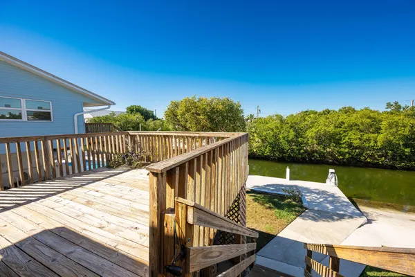 a view of a balcony with wooden floor and lake view