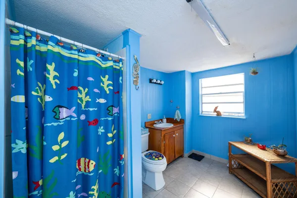 a room with window and musical instruments