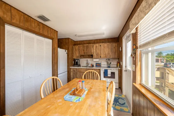 a view of a kitchen with kitchen island dining table and chairs