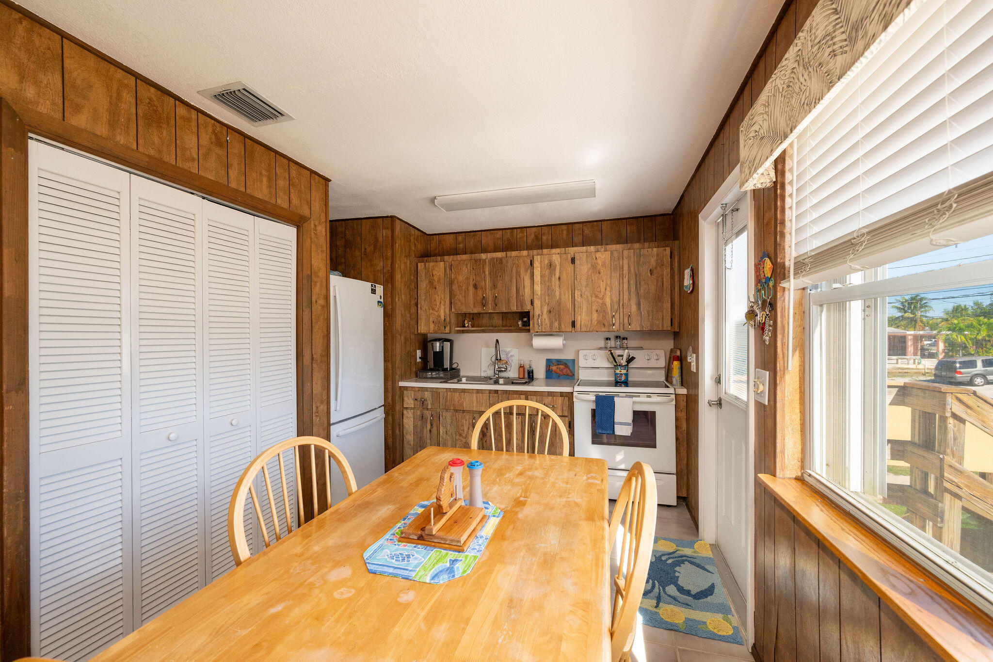 3856 Donna Road Big Pine Key, FL 33043 - Photo 6 of 28 a view of a kitchen with kitchen island dining table and chairs