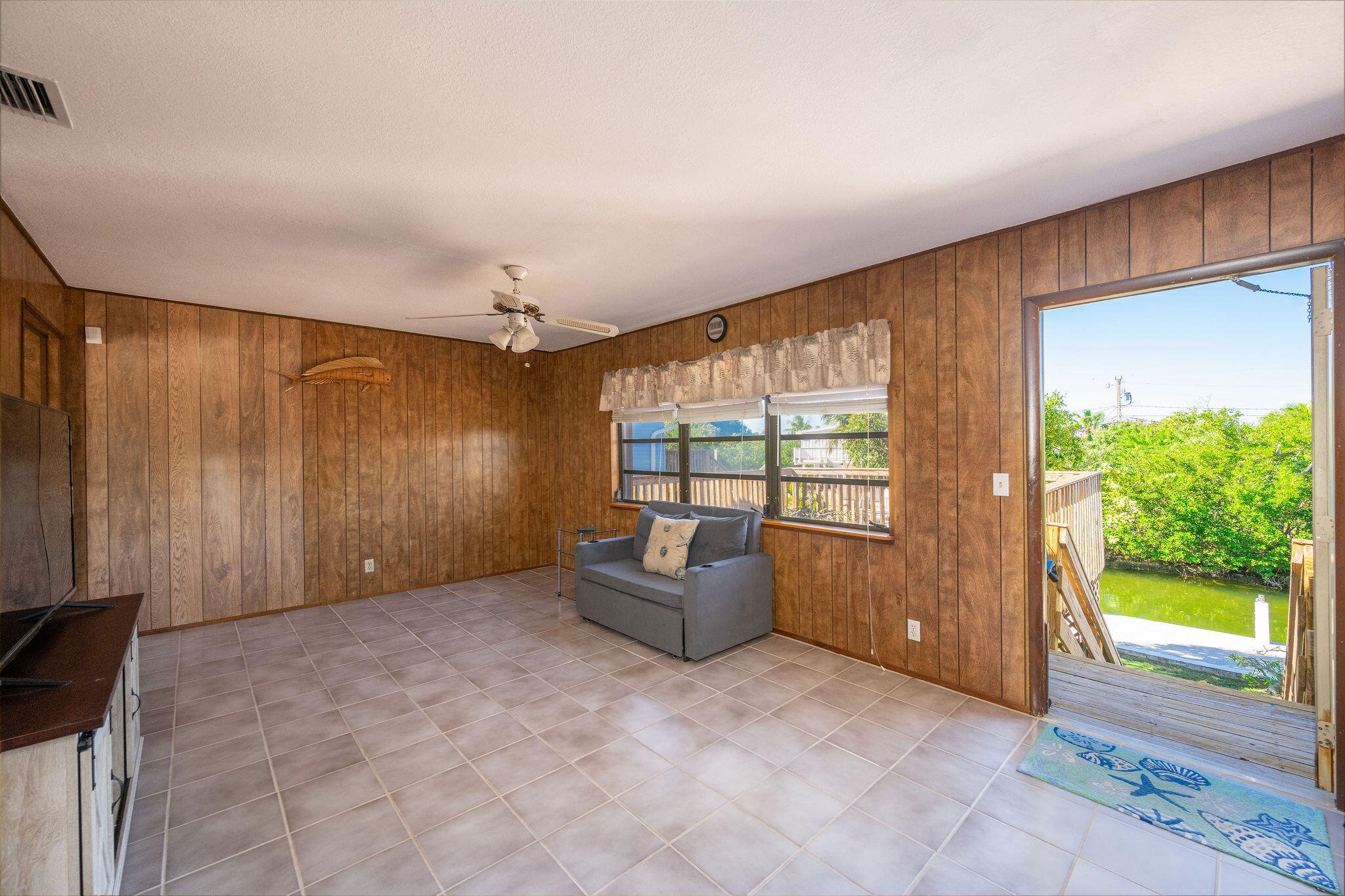 3856 Donna Road Big Pine Key, FL 33043 - Photo 9 of 28 a living room with furniture and a flat screen tv