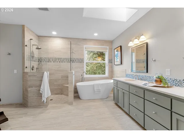 a bathroom with a tub sink and mirror