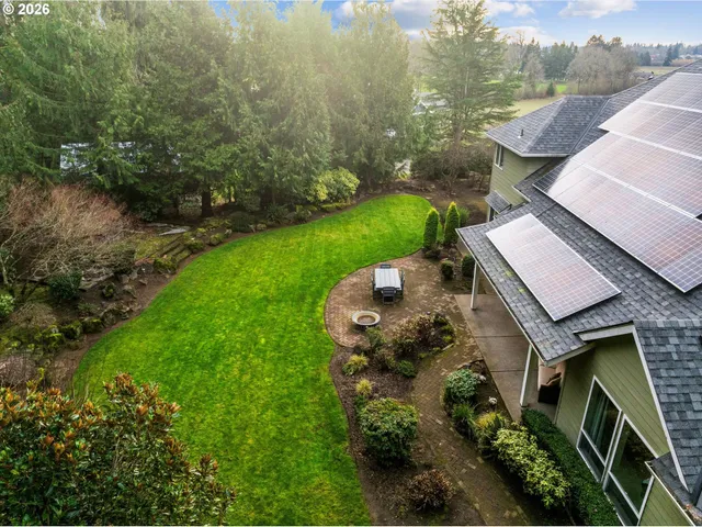 an aerial view of a house with garden space and a street view