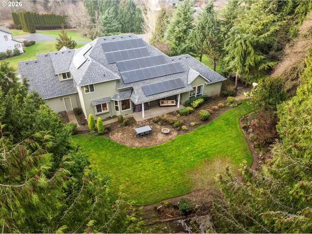 a aerial view of a house with swimming pool and a yard