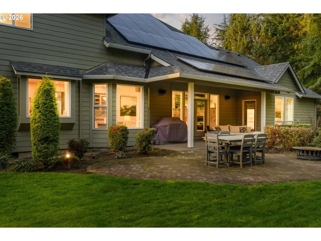 a view of a house with backyard porch and sitting area