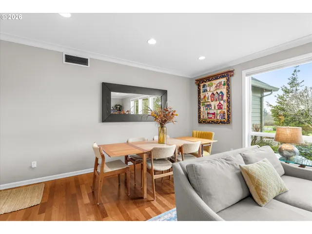 a living room with furniture and a painting on the wall