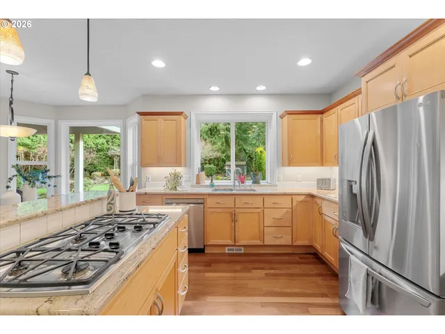 a kitchen with a stove a sink and a refrigerator