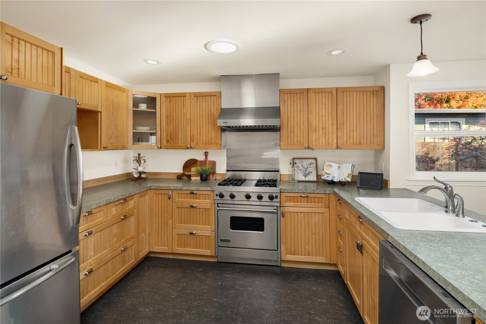 5230 242nd Street Southwest Mountlake Terrace, WA 98043 - Photo 14 of 39 a kitchen with stainless steel appliances granite countertop a stove sink and refrigerator