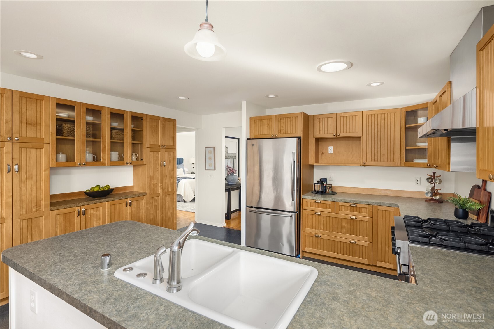 5230 242nd Street Southwest Mountlake Terrace, WA 98043 - Photo 16 of 39 a kitchen with a refrigerator a sink and cabinets
