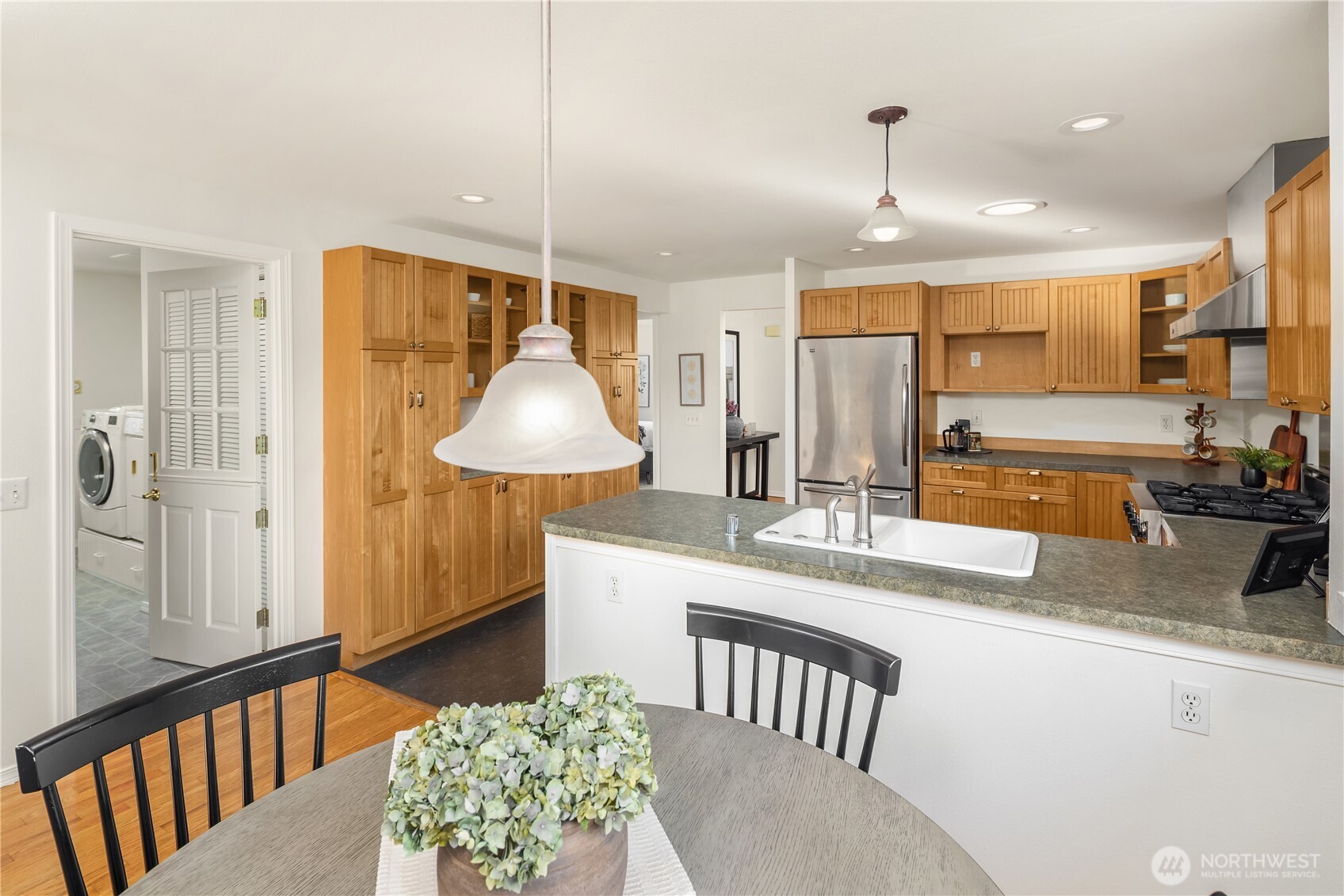 5230 242nd Street Southwest Mountlake Terrace, WA 98043 - Photo 18 of 39 a kitchen with stainless steel appliances kitchen island granite countertop a sink and cabinets