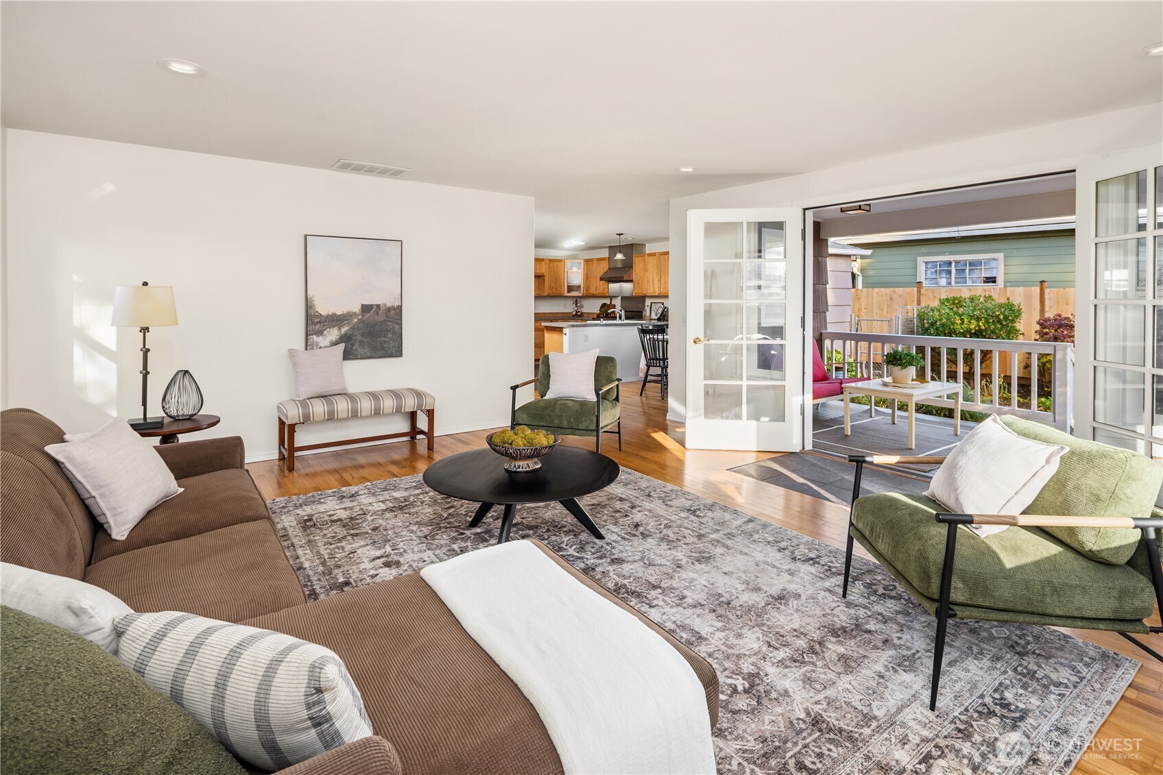 5230 242nd Street Southwest Mountlake Terrace, WA 98043 - Photo 23 of 39 a living room with furniture couches and a dining table with wooden floor