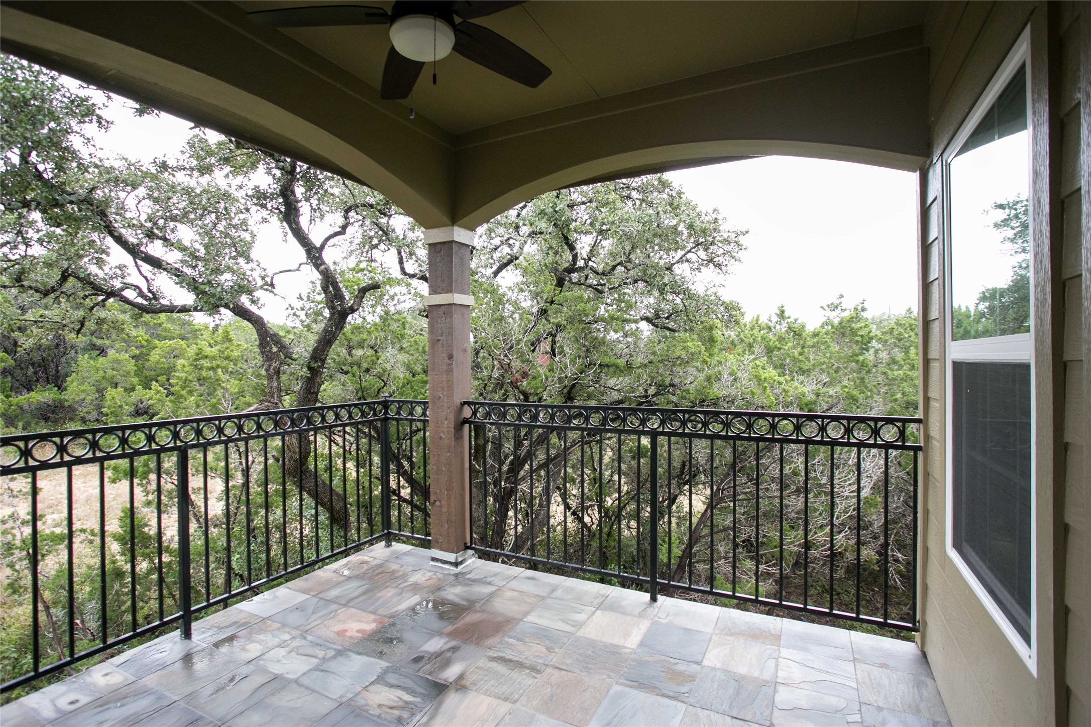 4301 Mansfield Dam Road, Unit 2102 Austin, TX 78734 - Photo 9 of 9 An inviting balcony offers serene views of mature trees and surrounding nature.