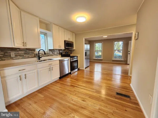 a kitchen with stainless steel appliances granite countertop a sink and cabinets