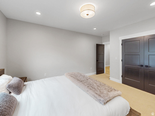 355 East Overlook Loop Hideout, UT 84036 - Photo 31 of 40 Bedroom #3 features neutral wall tones, recessed lighting, a central flush-mount light fixture, dark panel doors with matte black hardware, and carpet flooring