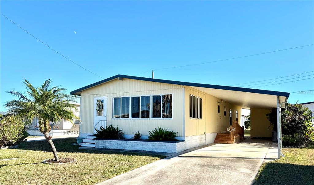 340 Peace Manor Palmetto, FL 34221 - Photo 1 of 38 a front view of a house with a yard