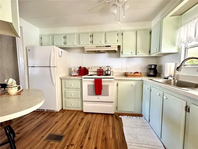 a kitchen with a sink a stove and refrigerator
