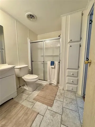 a bathroom with a toilet and a shower