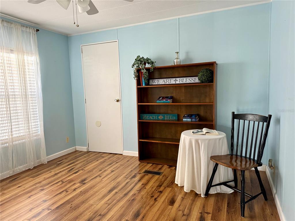 340 Peace Manor Palmetto, FL 34221 - Photo 24 of 38 a room with a chair and wooden floor